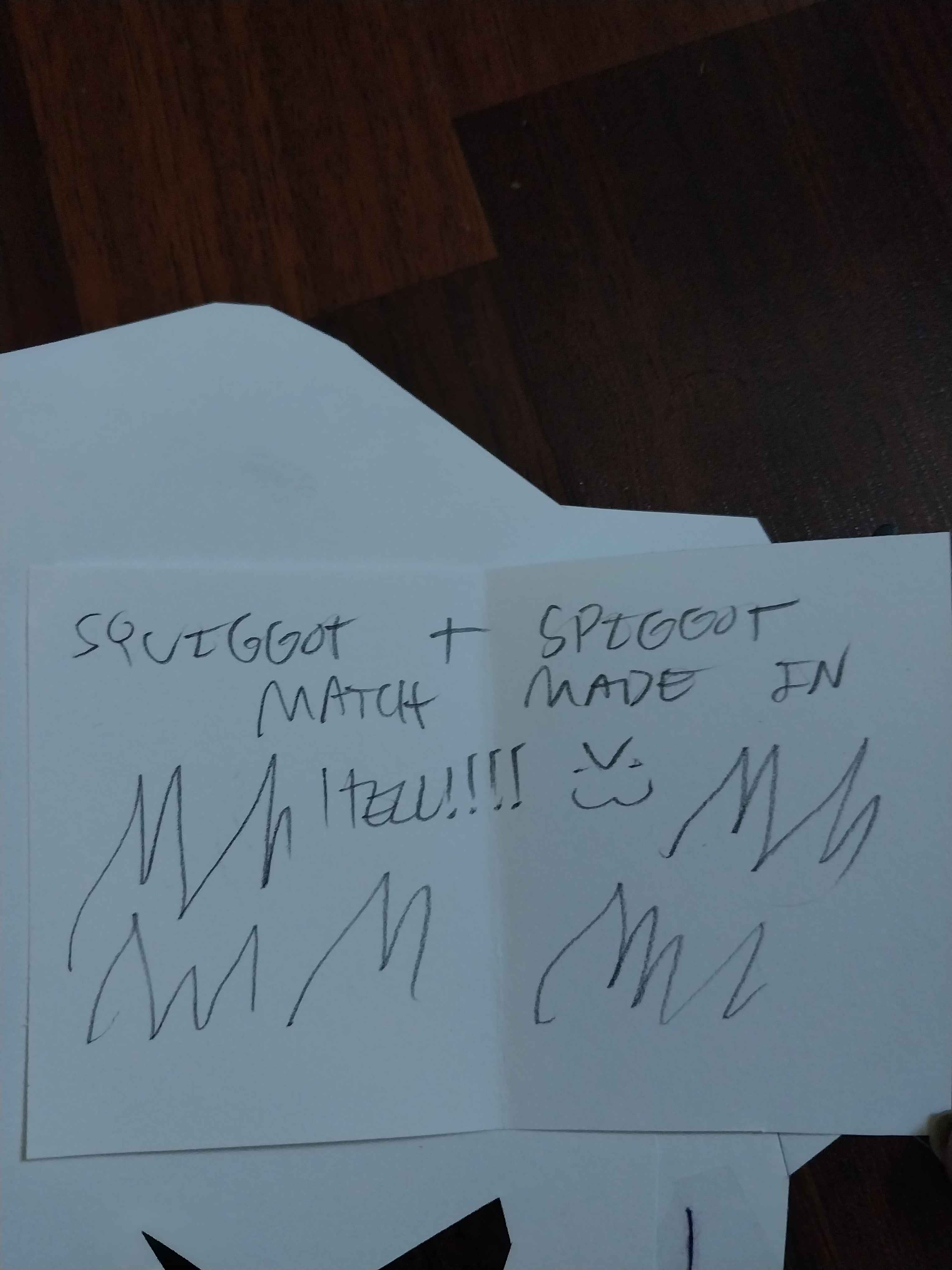 A note on the back of the spider craft says 'squiggot + spiggot match made in hell' with fire in the background, drawn in pencil.